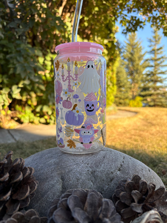 Tumbler with Halloween-themed stickers on a rock outdoors